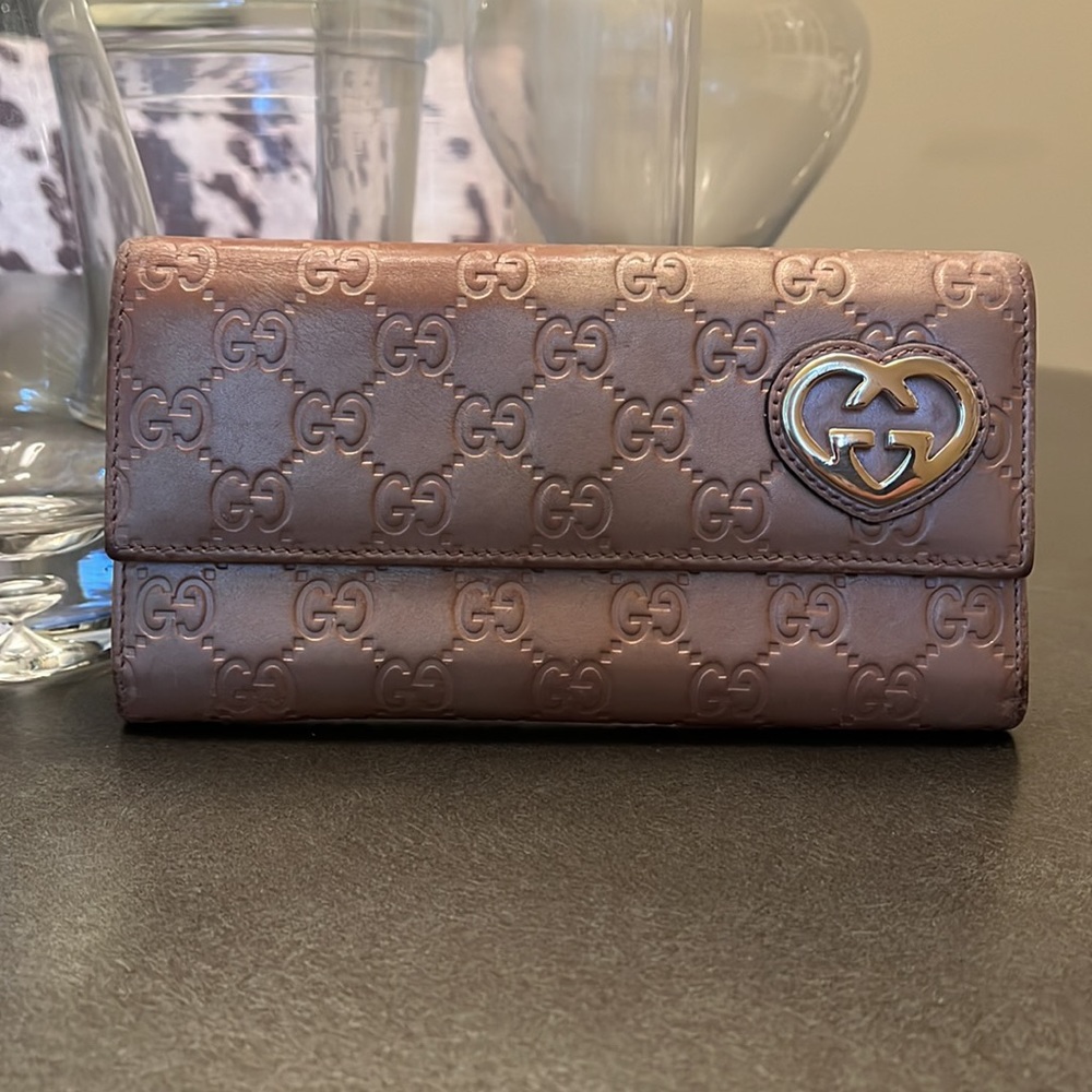 Gucci Guccisma leather wallet. Peach/beige in color with gold heart accent.